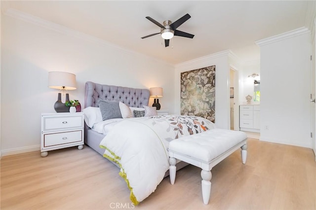 bedroom with crown molding, light hardwood / wood-style flooring, ceiling fan, and ensuite bathroom