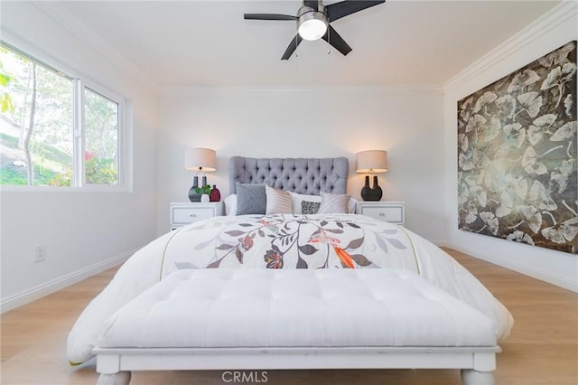 bedroom with crown molding, ceiling fan, and light wood-type flooring