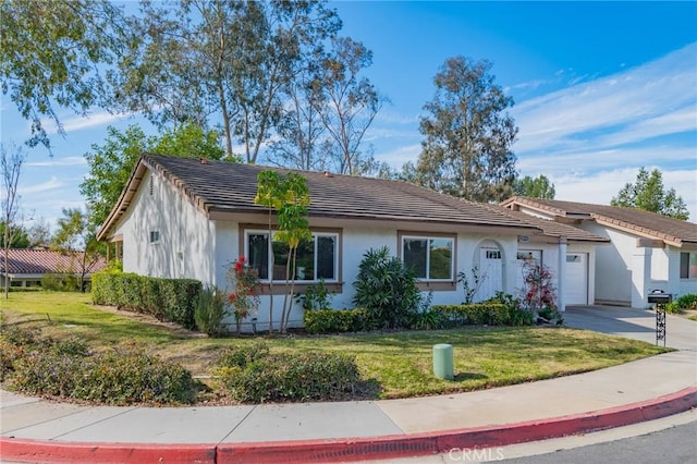 single story home featuring a garage and a front lawn