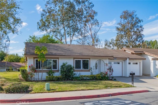 single story home with a garage and a front yard