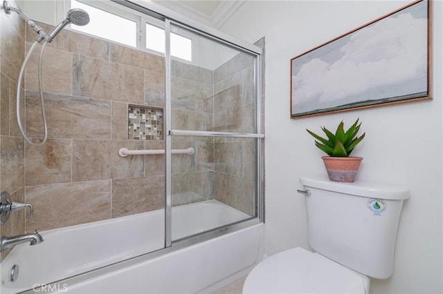 bathroom with toilet and combined bath / shower with glass door