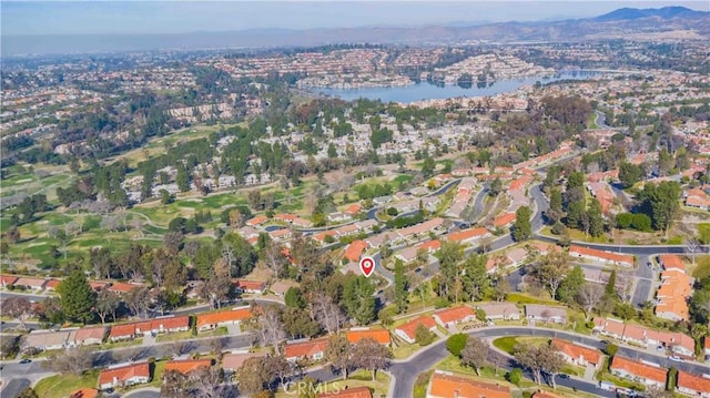 drone / aerial view featuring a water and mountain view