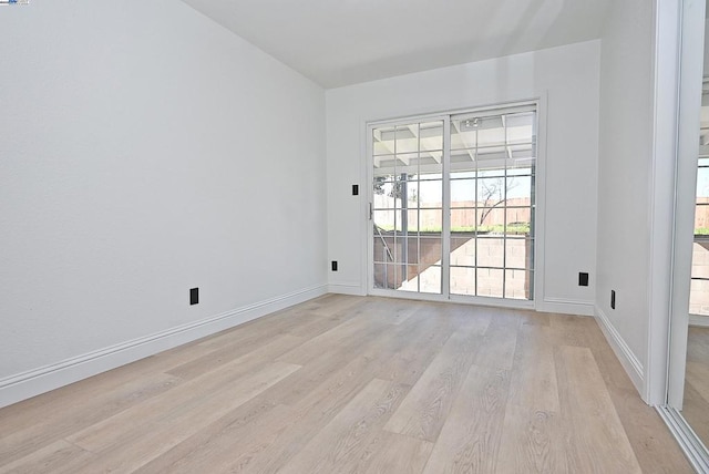 spare room featuring light wood-type flooring