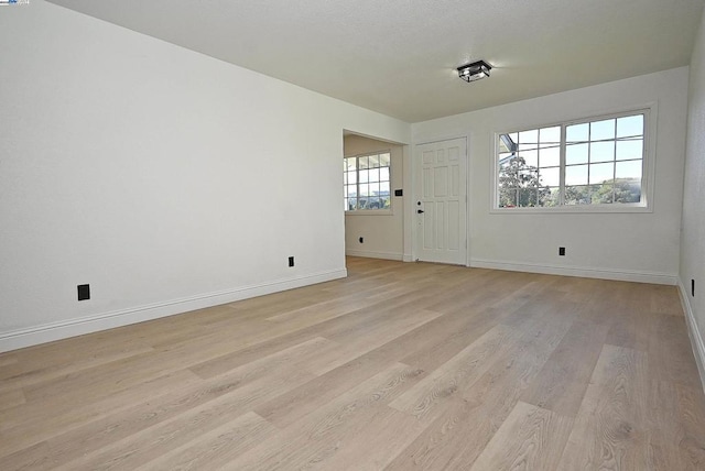 unfurnished room with light hardwood / wood-style flooring