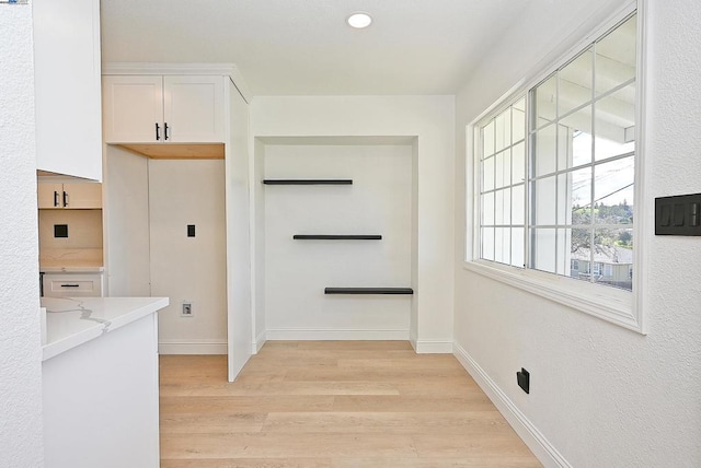 laundry room with light wood-type flooring