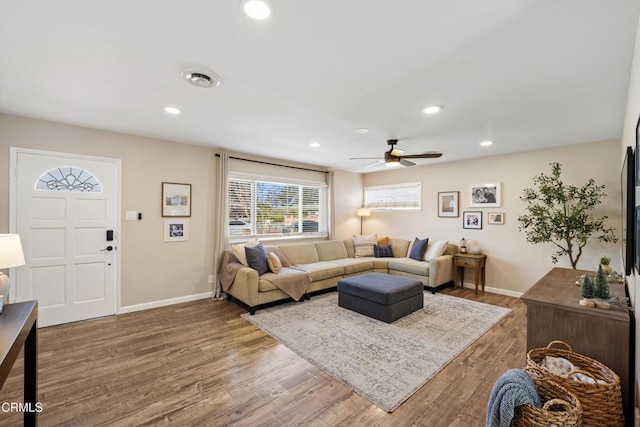 living room with ceiling fan and dark hardwood / wood-style flooring