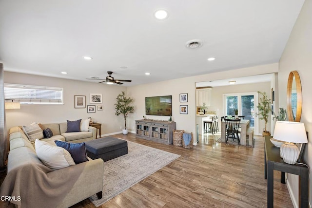 living room with hardwood / wood-style floors and ceiling fan