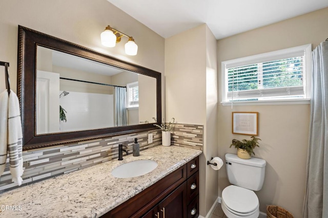 bathroom with vanity, decorative backsplash, a shower with curtain, and toilet