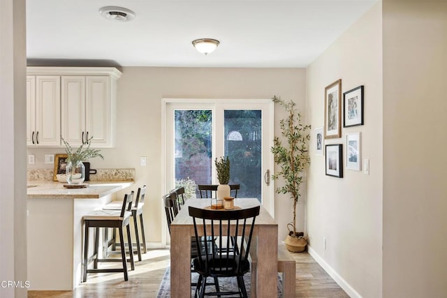 dining space featuring light hardwood / wood-style floors