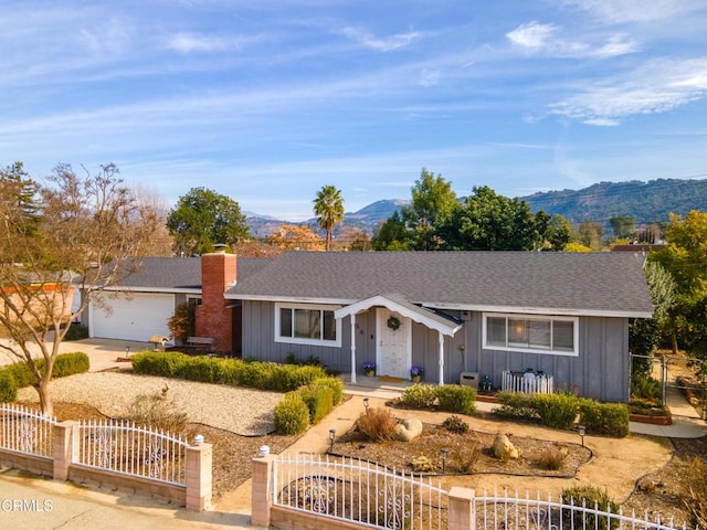 ranch-style house with a mountain view and a garage