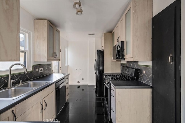 kitchen featuring dark tile patterned flooring, sink, light brown cabinets, and black appliances