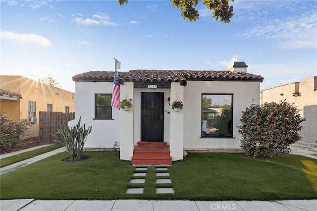 mediterranean / spanish-style home featuring a front lawn