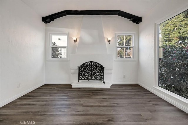 unfurnished living room featuring lofted ceiling and dark hardwood / wood-style floors