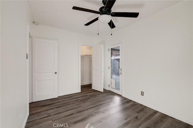 unfurnished bedroom featuring dark hardwood / wood-style flooring, access to outside, a closet, and ceiling fan