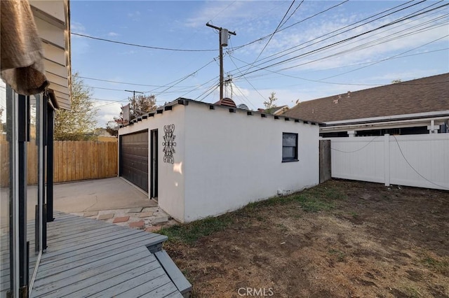 view of side of home featuring an outbuilding and a garage