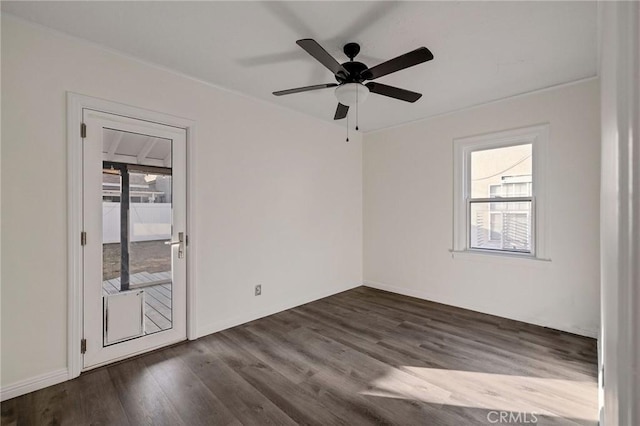 empty room with dark hardwood / wood-style floors and ceiling fan