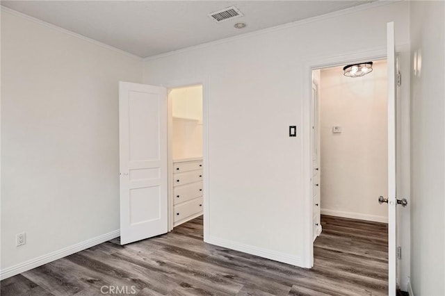 unfurnished bedroom with ornamental molding and dark hardwood / wood-style flooring