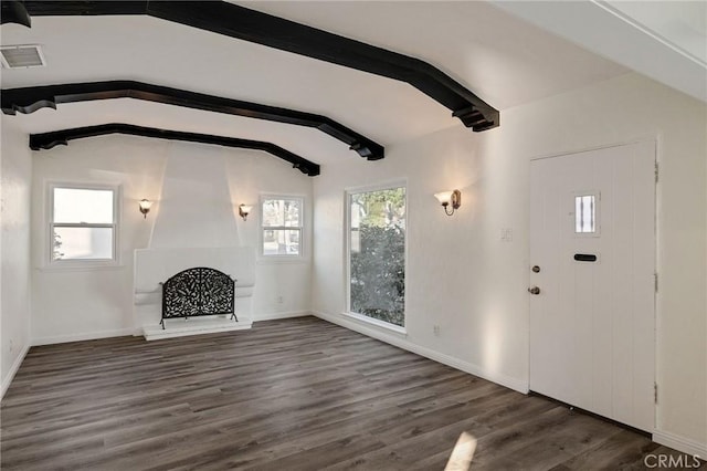 unfurnished living room featuring lofted ceiling with beams, a fireplace, and dark hardwood / wood-style flooring