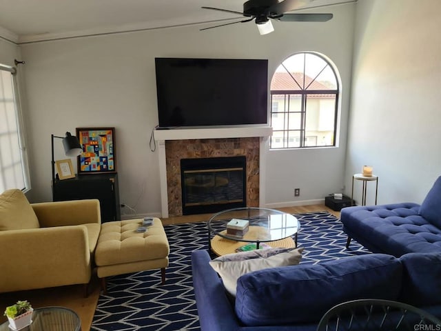 living room featuring hardwood / wood-style flooring, a fireplace, and ceiling fan