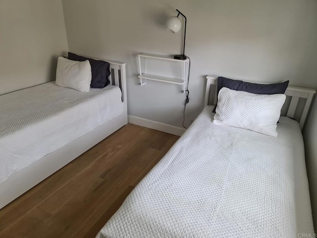 bedroom with dark wood-type flooring