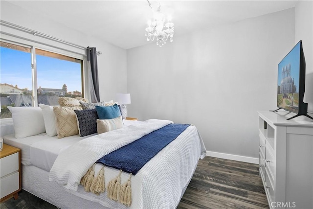 bedroom featuring dark hardwood / wood-style floors and a chandelier