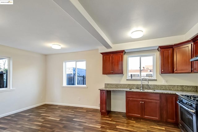 kitchen featuring light stone counters, sink, gas range, and dark hardwood / wood-style flooring