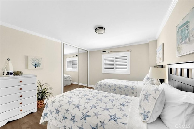 bedroom featuring dark hardwood / wood-style flooring, ornamental molding, and a closet