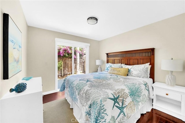 bedroom with access to exterior and hardwood / wood-style floors