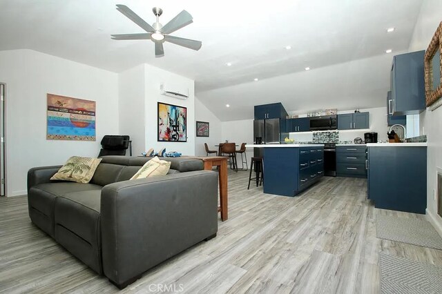 living room featuring a wall mounted AC, ceiling fan, light hardwood / wood-style floors, and vaulted ceiling