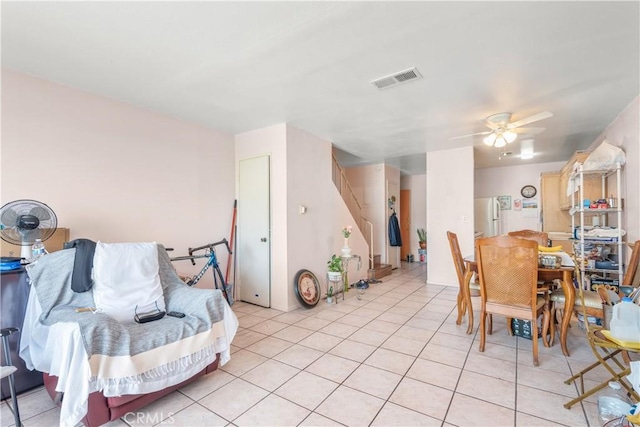 dining room with light tile patterned floors and ceiling fan