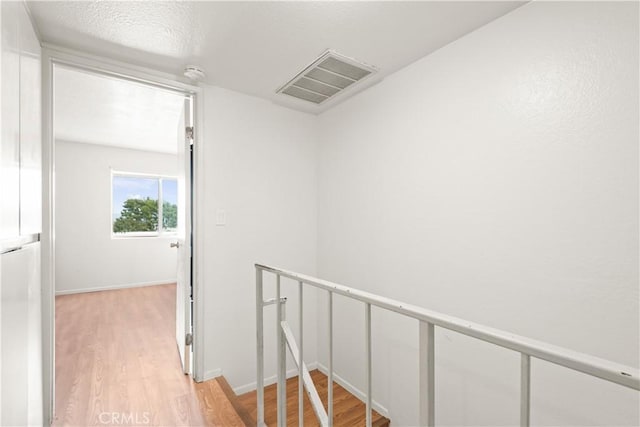 corridor with light hardwood / wood-style flooring