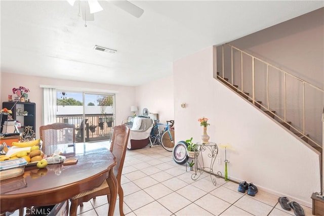 tiled dining room featuring ceiling fan