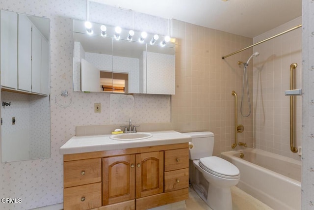 full bathroom featuring tiled shower / bath, vanity, and toilet