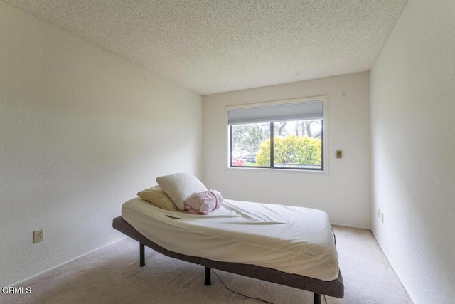 carpeted bedroom featuring a textured ceiling