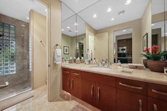 bathroom featuring vanity and an enclosed shower