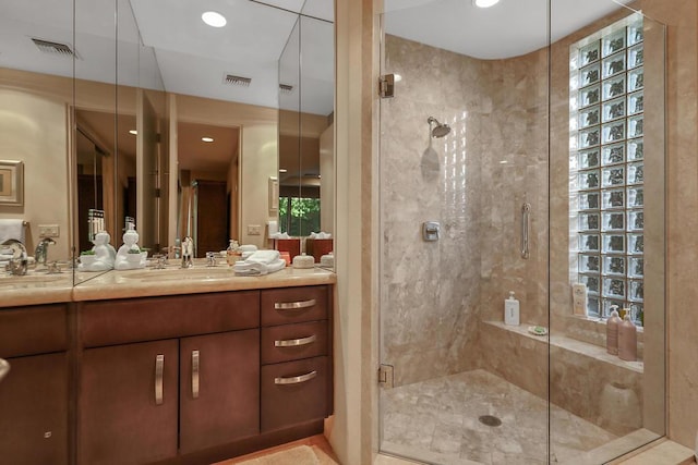 bathroom with vanity and a shower with shower door