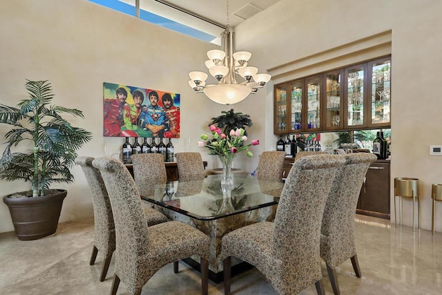 dining room featuring an inviting chandelier and a high ceiling