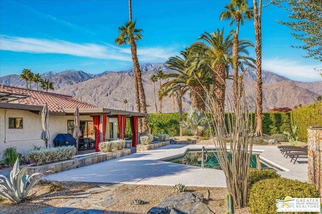 exterior space featuring a mountain view and a patio