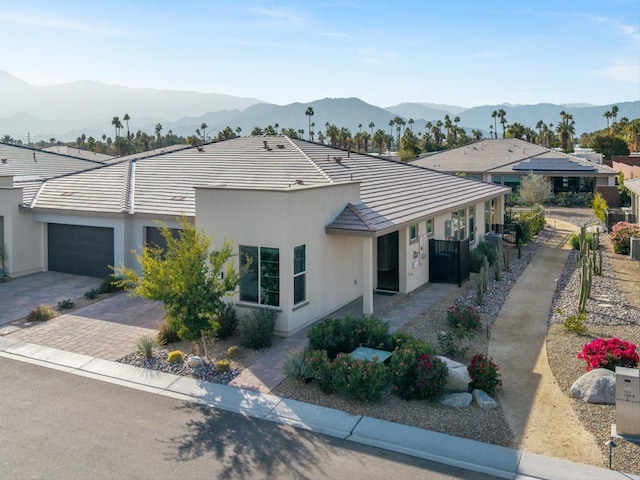 view of front of home featuring a garage and a mountain view