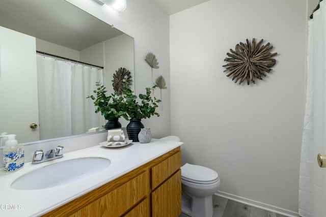 bathroom featuring hardwood / wood-style flooring, vanity, and toilet