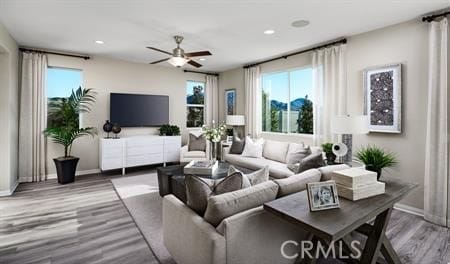 living room featuring hardwood / wood-style floors and ceiling fan