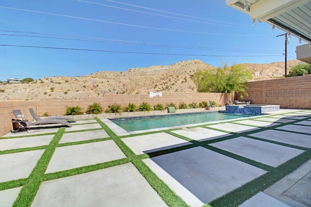 view of swimming pool featuring a mountain view and a patio area