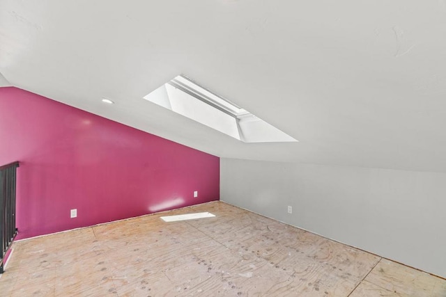 bonus room featuring vaulted ceiling with skylight