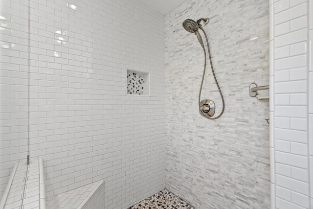 bathroom featuring tiled shower