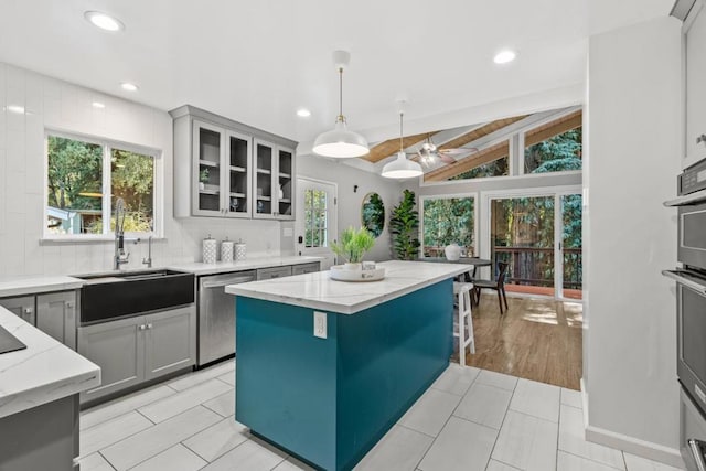 kitchen with gray cabinets, dishwasher, sink, and pendant lighting