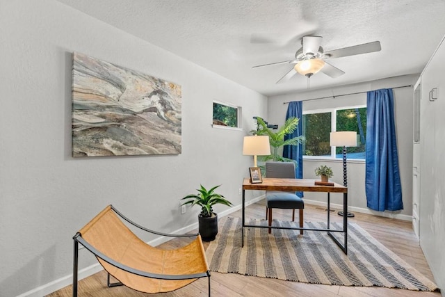 office space featuring hardwood / wood-style floors, a textured ceiling, and ceiling fan