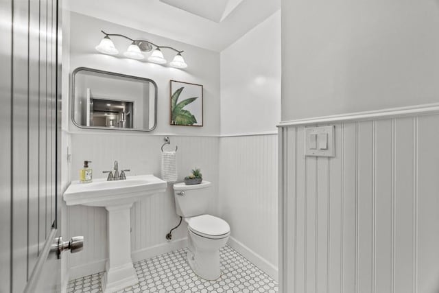 bathroom featuring sink, tile patterned floors, and toilet