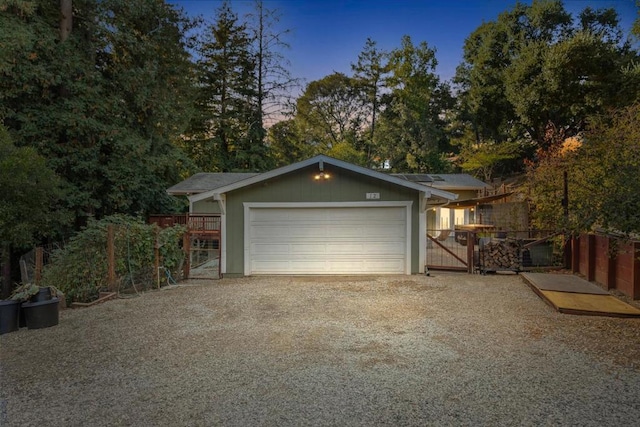 view of garage at dusk