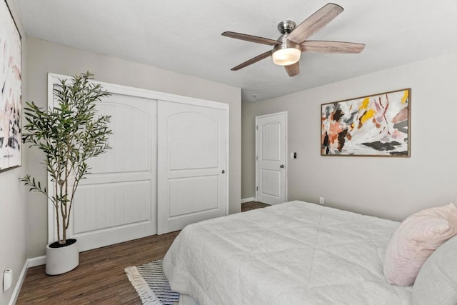 bedroom featuring dark hardwood / wood-style flooring, a closet, and ceiling fan