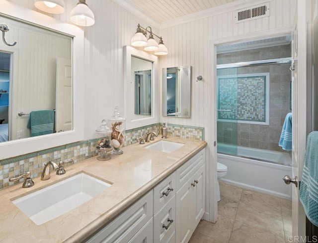 full bathroom with crown molding, bath / shower combo with glass door, vanity, decorative backsplash, and toilet